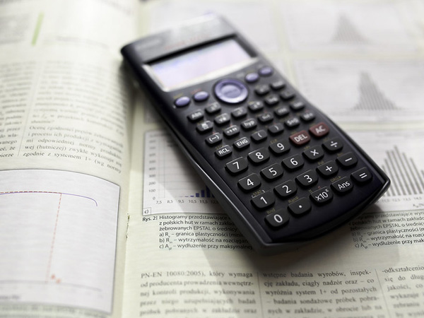 A calculator sits on top of a scientific text