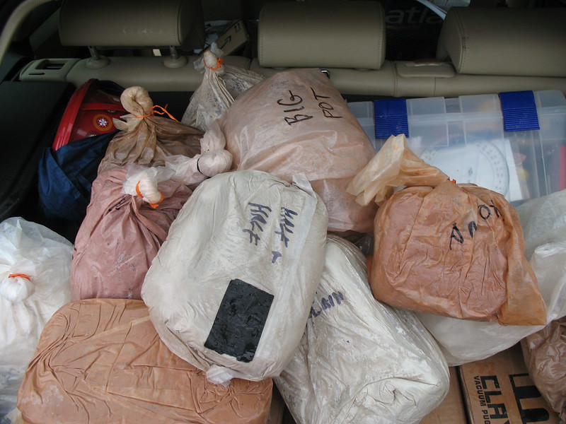 Bags of clay in the trunk of a car.