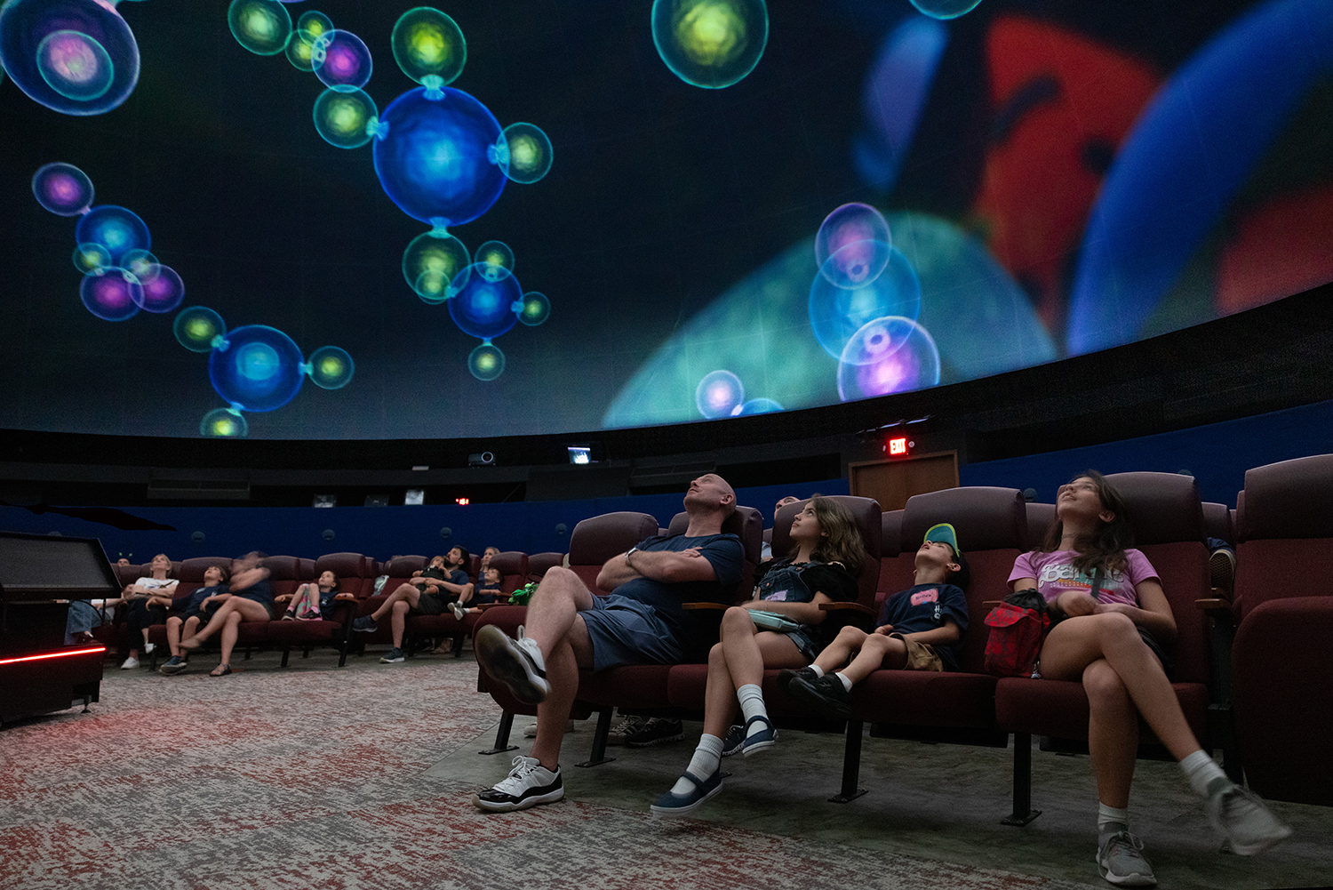 People look up at the ceiling at the Morehead Planetarium.