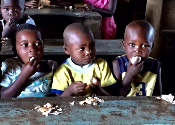 Preschoolers in the rural village of Dzama, Malawi eat a hard boiled eggs.
