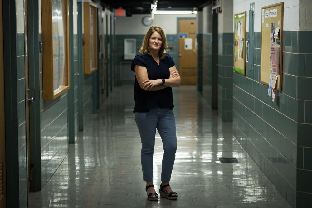 Photo of Dorothy Espelage standing in a high school hallway with her arms crossed.