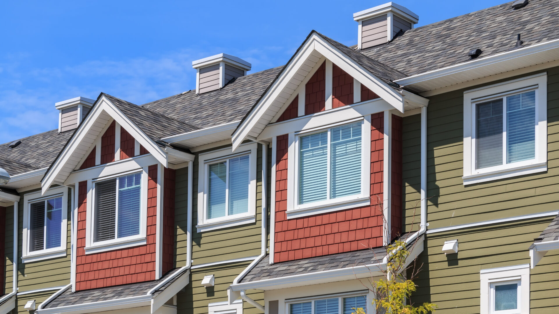 Looking up at windows of houses.