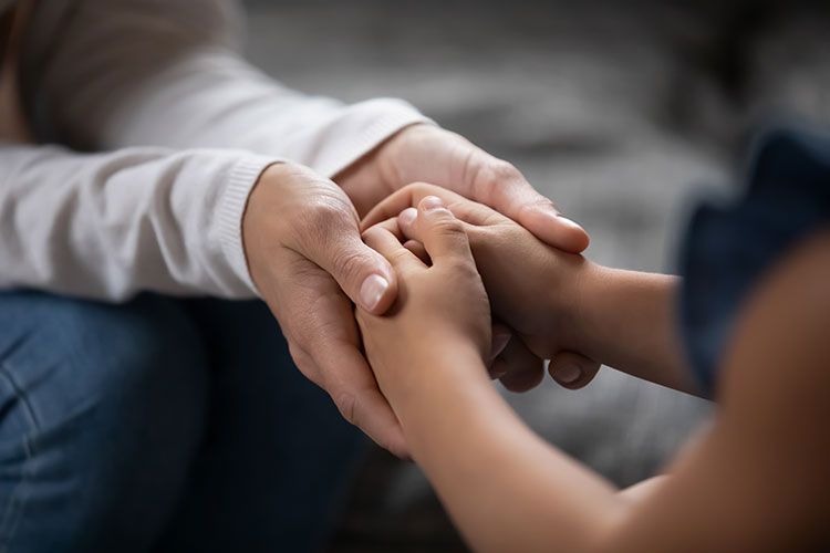 Older hands holding younger hands