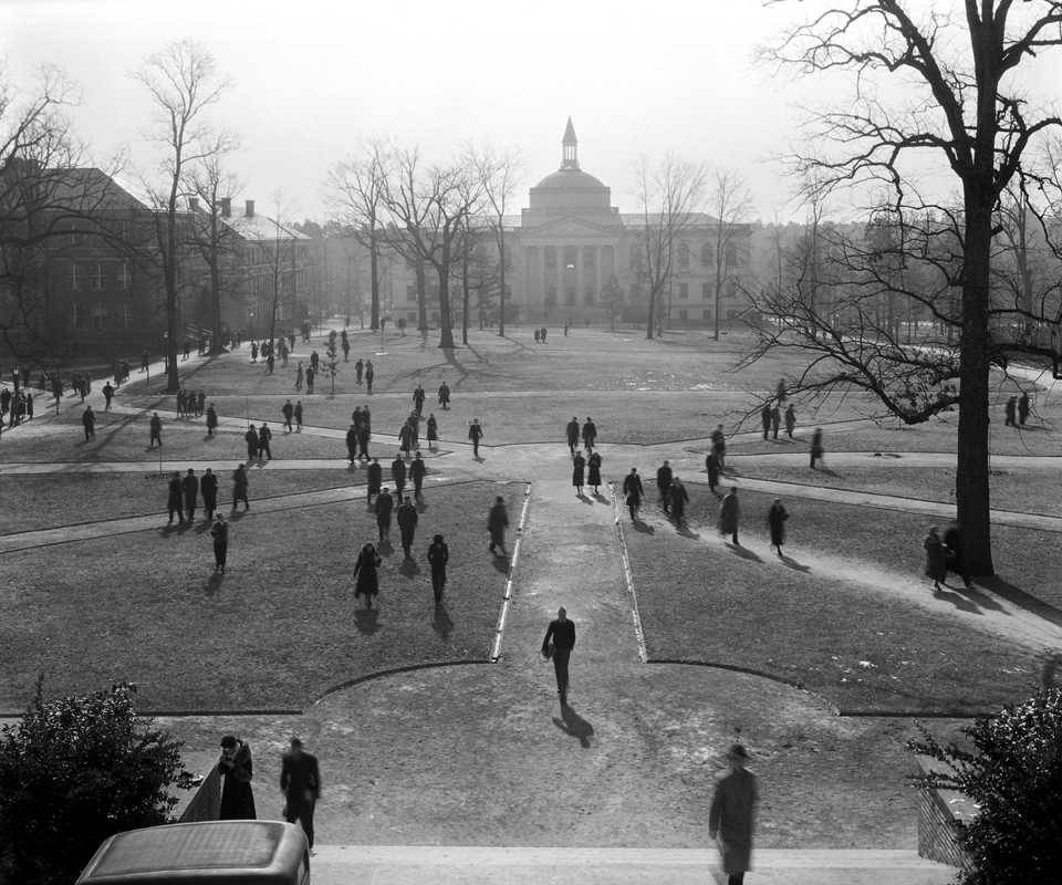 Old, black and white photo of the quad on UNC campus.