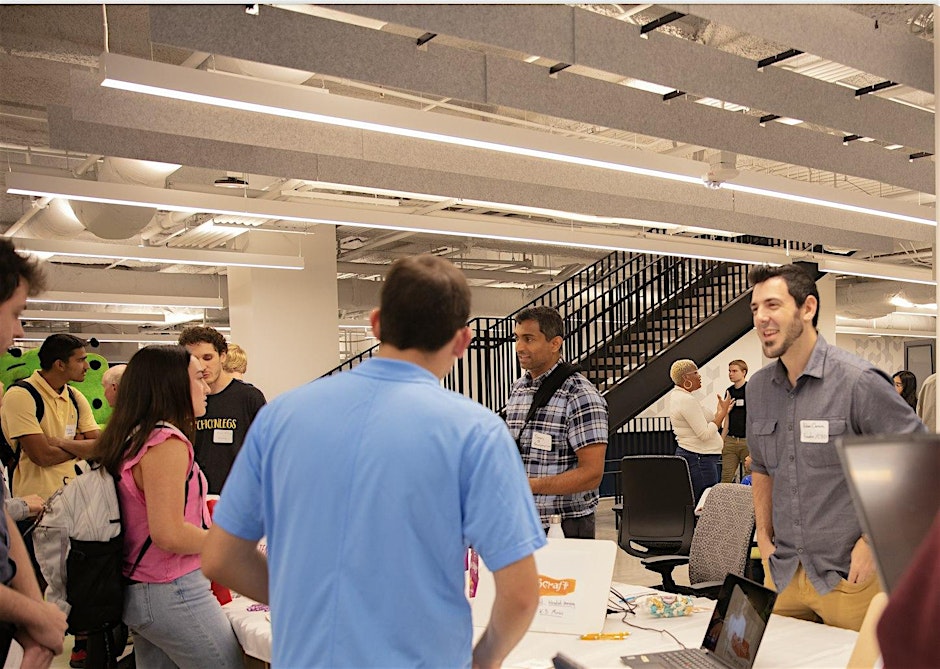 A group of people talking at an event.