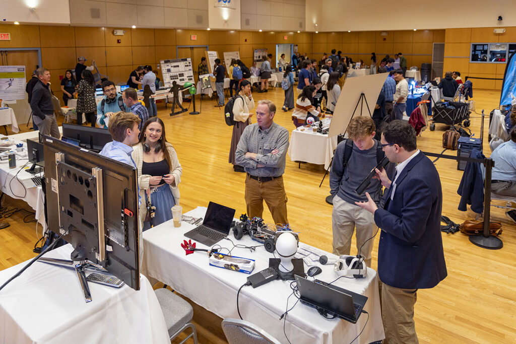 Rameses tries on body tracking tech from a lab booth at the Research and Discovery fair.
