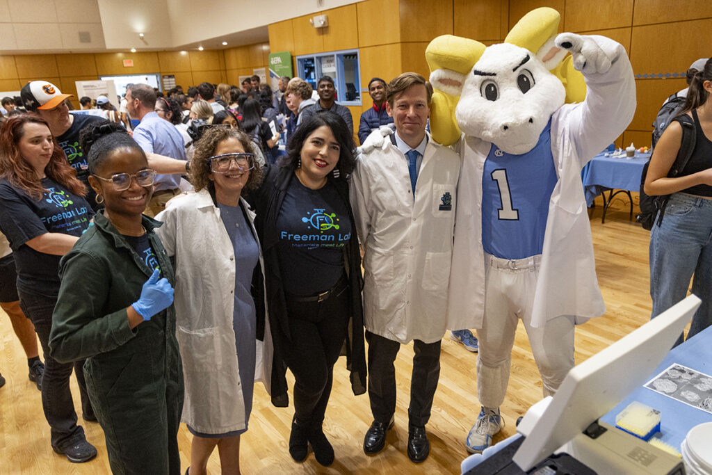 Vice Chancellor for Research Penny Gordon-Larsen, Chancellor Lee Roberts, Rameses, Ronit Freeman, and Kameryn Hinton pose for a group picture at the Research and Discovery Fair.